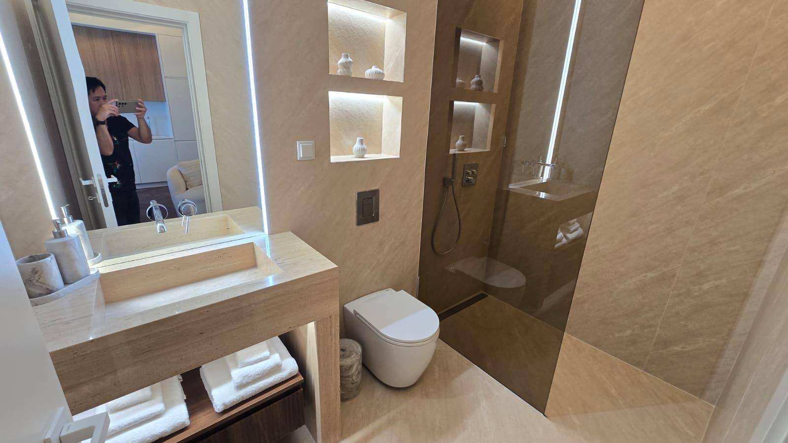 Bathroom: floating vanity, LED mirror, walk-in shower